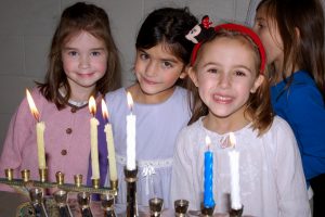 lighting chanukah menorahs