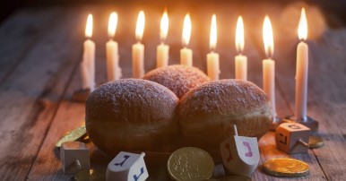 Hanukkah candles, donuts, gelt and dreidels